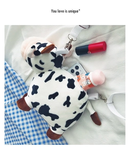 Capacity of the plush cow print crossbody bag showing space for phone and makeup
