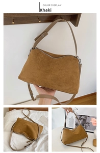 Detail view of khaki suede handbag showing premium texture, metal zipper and adjustable strap