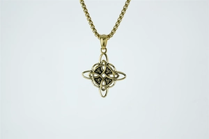 Detail of golden Celtic knot pendant with black enamel inlay on a sturdy box chain