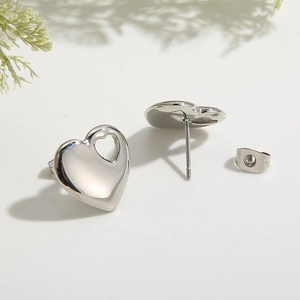 Elegant silver hollow heart stud earrings made of titanium steel with smooth metal finish