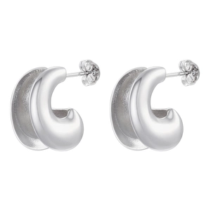 Detail of high-polish U-shaped silver earrings showing sleek curves and glossy finish
