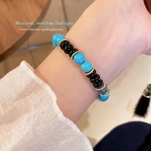 Beaded bracelet featuring blue crystal, green stone, and black onyx with gold metal spacers