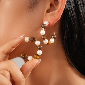 16K gold plated C-shaped hoop earrings with tiger eye beads and pearls on model