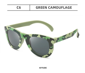 Detail view of green camouflage plastic party sunglasses for children at 45 degree angle
