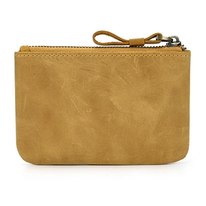 Close-up of brown genuine leather coin purse showing natural texture and zipper detail