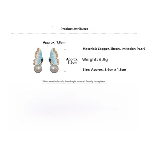 Detail showing butterfly earrings size 3.6x1.8cm made of copper zircon and pearl