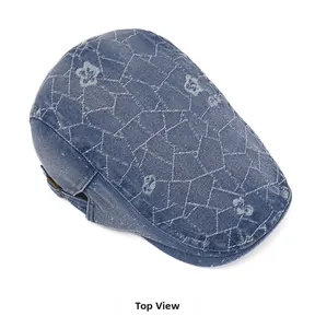 Top view of blue denim newsboy cap with white star stitching and metallic buckle detail