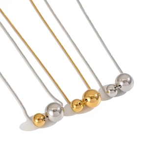 Three minimalist snake chain necklaces with double ball pendants in gold and silver finish