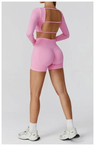 Pink seamless yoga set featuring U-shaped back cutout top and scrunch butt gym shorts