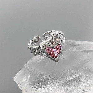 Detail of molten silver ring featuring a pink heart zircon and thick chain link band