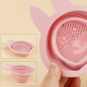 Macro detail of pink rabbit-shaped silicone makeup brush cleaner bowl with cleaning textures
