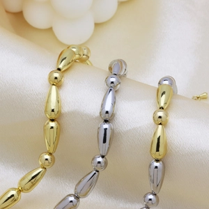 Chic 18k gold and silver plated bamboo joint chain with pearls on silk background