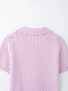 Detail of lavender pink knit top featuring vertical ribbing and a classic polo collar