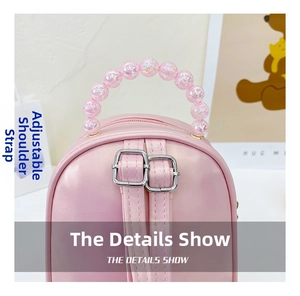 Detail of pink toddler backpack with iridescent pearl handle and adjustable silver straps