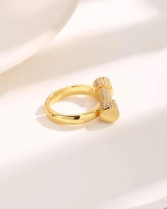 Luxury gold geometric ring featuring a cylinder bar paved with sparkling zircons