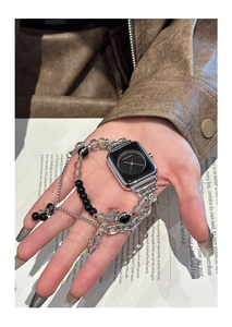 Silver metal chain Apple Watch strap with black beads and a star charm on wrist
