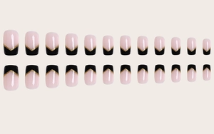 Detail of 24pcs square press-on nails featuring nude pink base and black V-shape tips