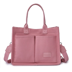 Pink canvas tote bag with front pockets and adjustable strap for women in 2025 style