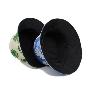 Reversible tropical leaf print bucket hats for sun protection in beige and blue