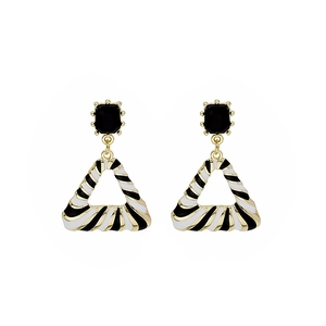 Geometric triangle earrings with black and white stripes and gold finish details