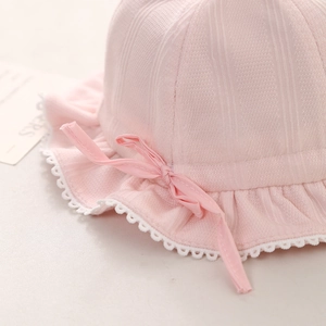 Pink knit baby sun hat with lace edge and sweet ribbon bow detail for girls
