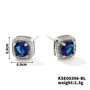 Detail view of 0.9cm square blue zircon stud earrings with silver pavé diamond halo