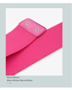 Detail of pink elastic woven belt with matching faux leather patch and metal snap buttons