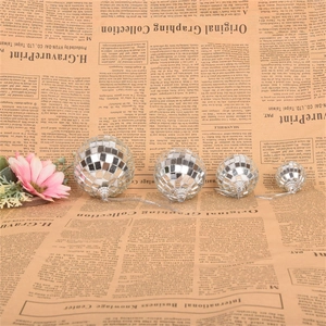 Set of four silver mirror disco balls in varying sizes for cake and party decoration