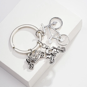 Detail of silver alloy keychain with three unique motorcycle and bicycle pendants