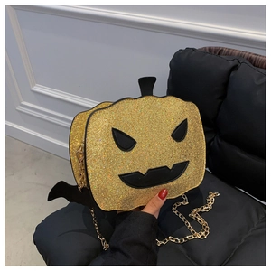 Macro detail of pumpkin bag featuring gold sequins, devil face and metal chain