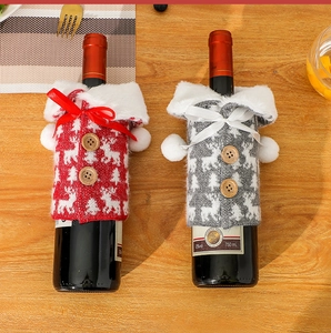 Detailed knitted Christmas wine bottle covers with reindeer patterns and faux fur collars