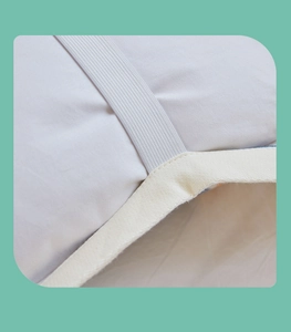 Detail of pure cotton gauze pillow towel with elastic strap and reinforced beige edging