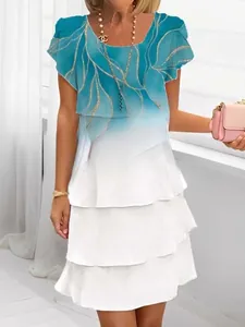 Detail of multi-layered ruffles on light blue gradient chiffon short sleeve dress