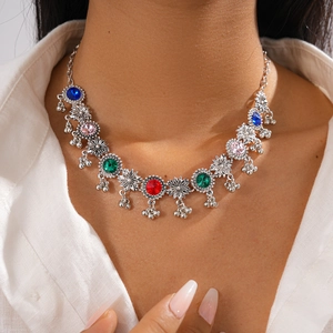 Vintage silver flower necklace with colorful crystals and hanging bell tassels on model