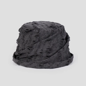Detail of distressed dark grey cotton bucket hat featuring ripped holes and frayed edges