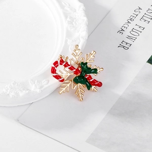Christmas snowflake brooch with red candy cane and green bow in gold enamel finish