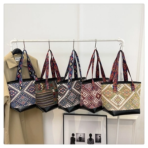 Detailed close-up of five colorful ethnic woven canvas tote bags with reinforced leather bases
