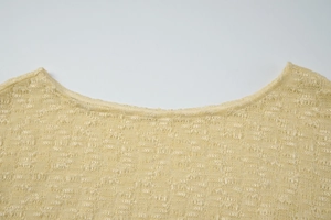 Detail view showing the fine knit texture and neckline of this French light yellow top