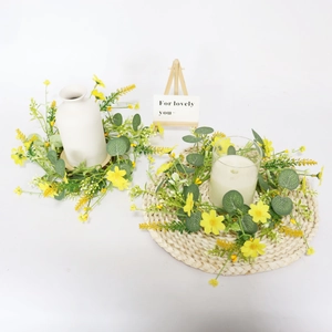 Spring daisy and eucalyptus candle ring wreath with decorative white ceramic vase