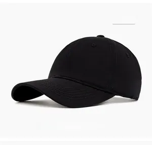 Close-up of black cotton twill baseball cap with curved brim and ventilation eyelets