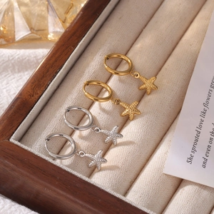 Starfish pendant hoop earrings in gold and silver finish on display box