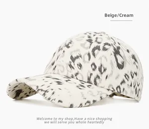 Detailed close-up of leopard print texture on a cream cotton baseball cap with ventilation holes