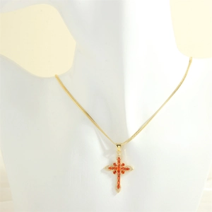 Detail of cross pendant featuring orange marquise stones and 18K gold plated chain