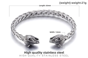 Macro detail of braided stainless steel texture and carved wolf head on open bracelet