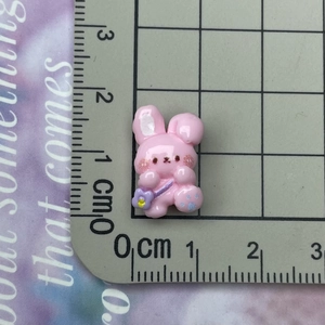 Detailed size view of a 1.5cm pink resin bunny charm with a purple crossbody bag