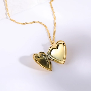 Golden heart-shaped locket necklace with water wave chain on a clean white background