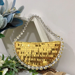 Detail of shimmering gold sequins and crystal rhinestones on a crescent evening bag