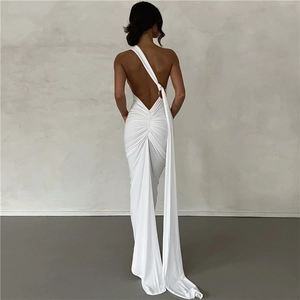 Detail of white backless halter dress with elegant pleated sash and sleek draped fabric