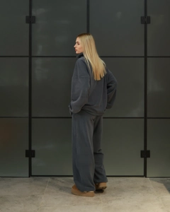 Detail view of oversized dark grey fleece tracksuit with soft knitted texture for women