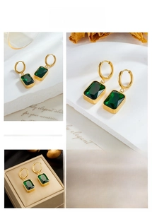 Detail of vintage square green gemstone drop earrings with gold-plated circular hoops